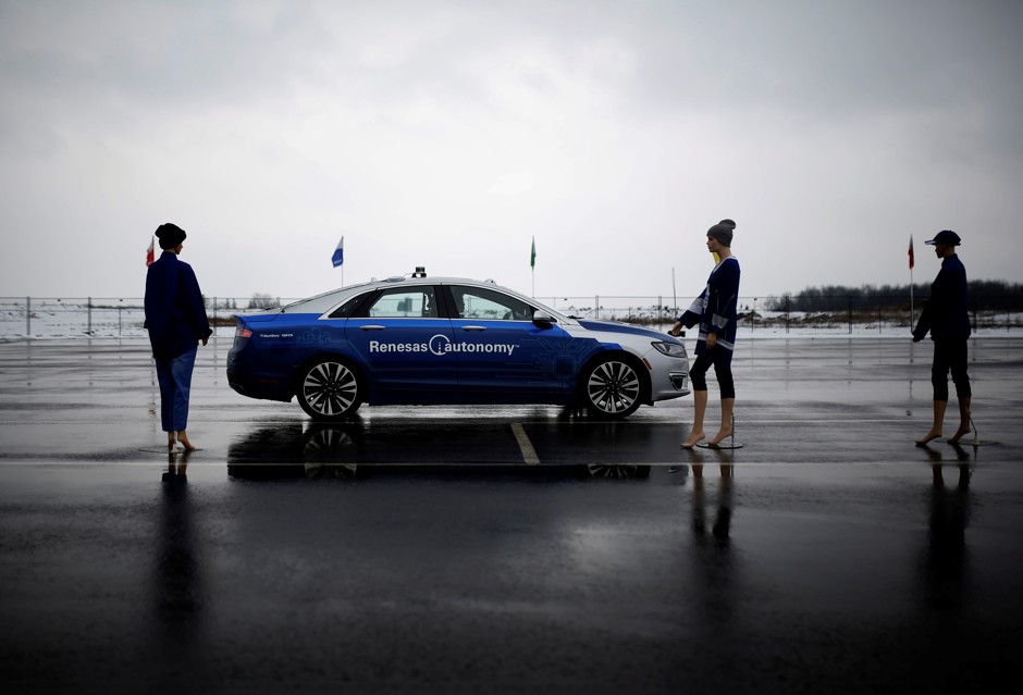 Mannequins pose with a self-driving car at a vehicle test track in Canada.