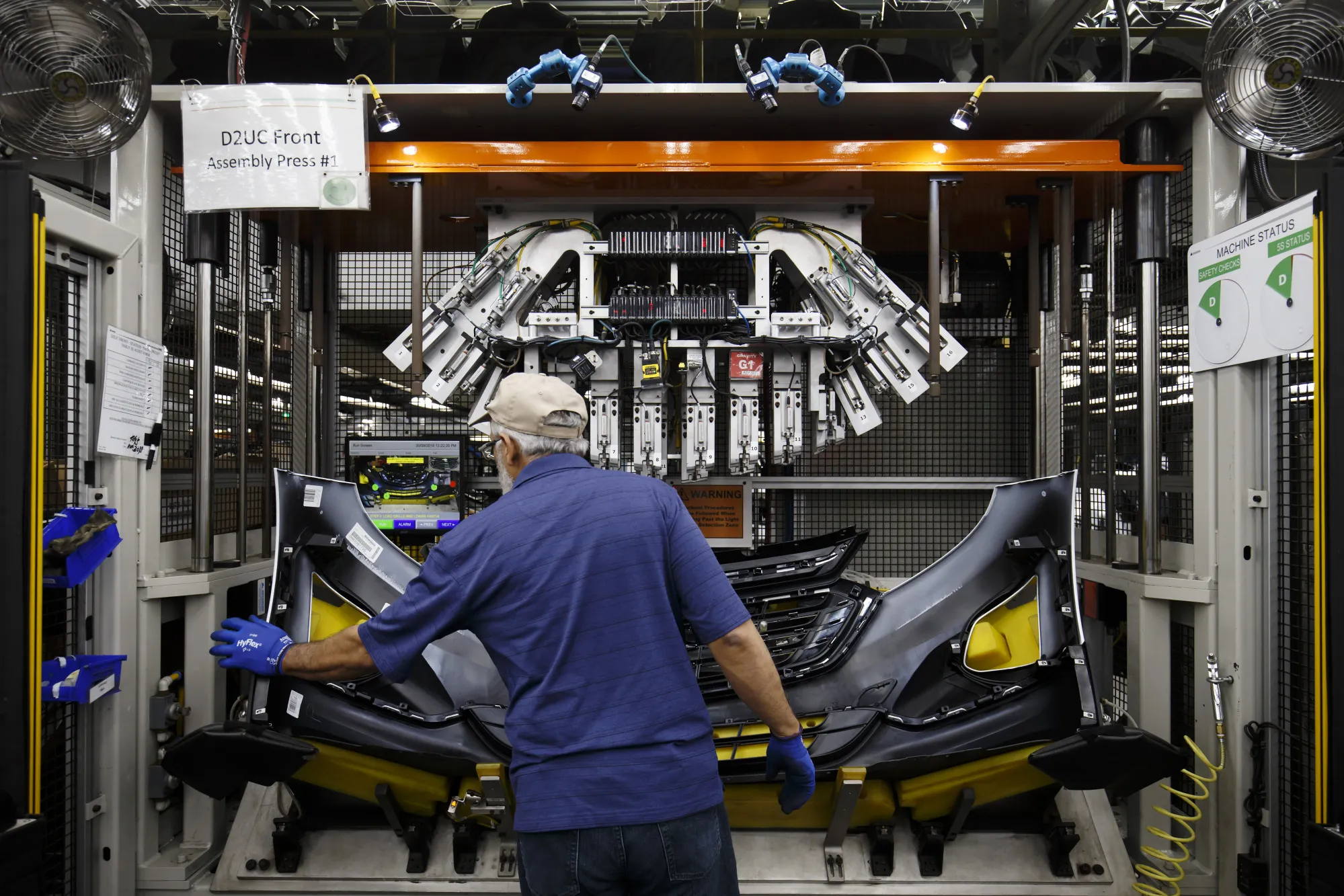 An employee assembles a bumper at an auto-parts plant in Guelph, Ontario in August 2018.