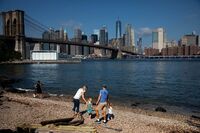 People walk along the water in Brooklyn, New York on Sept. 4.