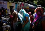 Residents fill water from a Delhi Municipal Corp. truck in New Delhi, on April 30.