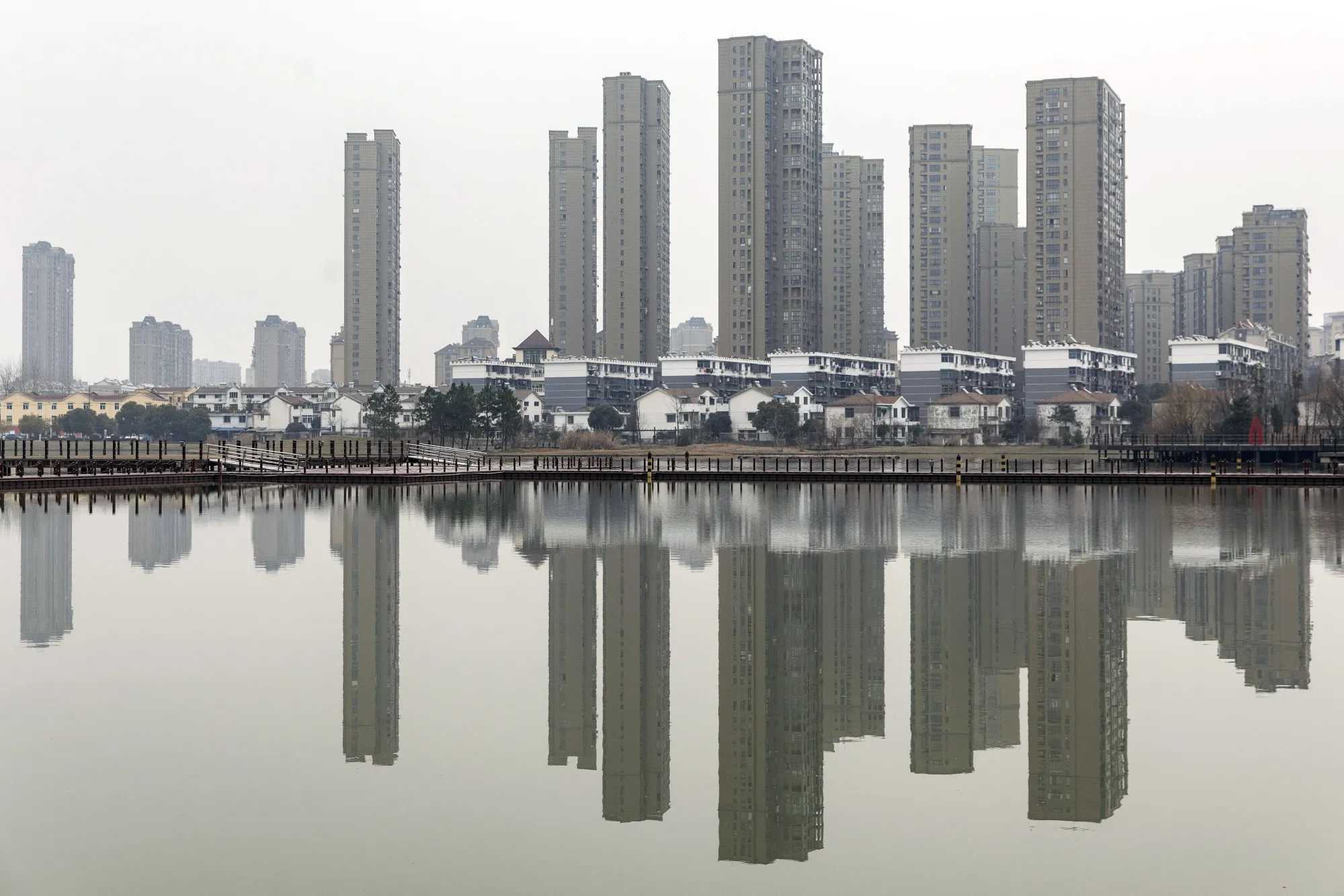 Residential buildings are reflected in water in Tongling, Anhui province, China.&nbsp;