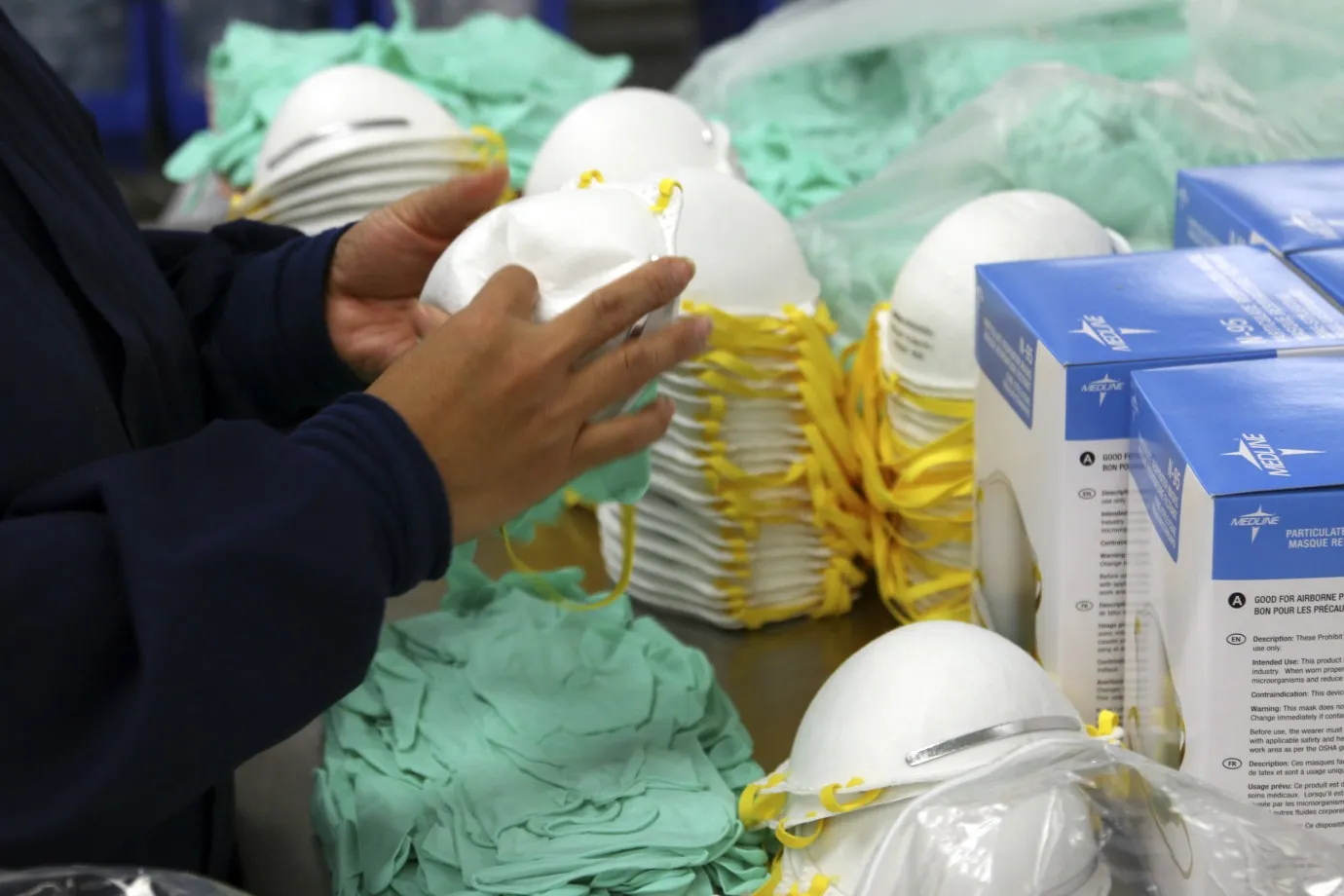 A Medline Industries worker gathers fluid resistant masks in Mundelein, Illinois.