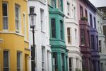 A lamp post stands in front of the colorful facades of residential properties in the Notting Hill district of London
