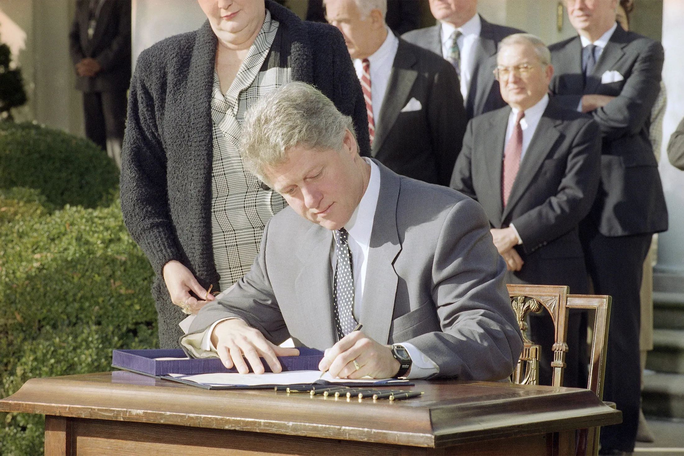 President Bill Clinton signs the Family Leave Bill into law during a ceremony in the Rose Garden on Feb. 6, 1993.