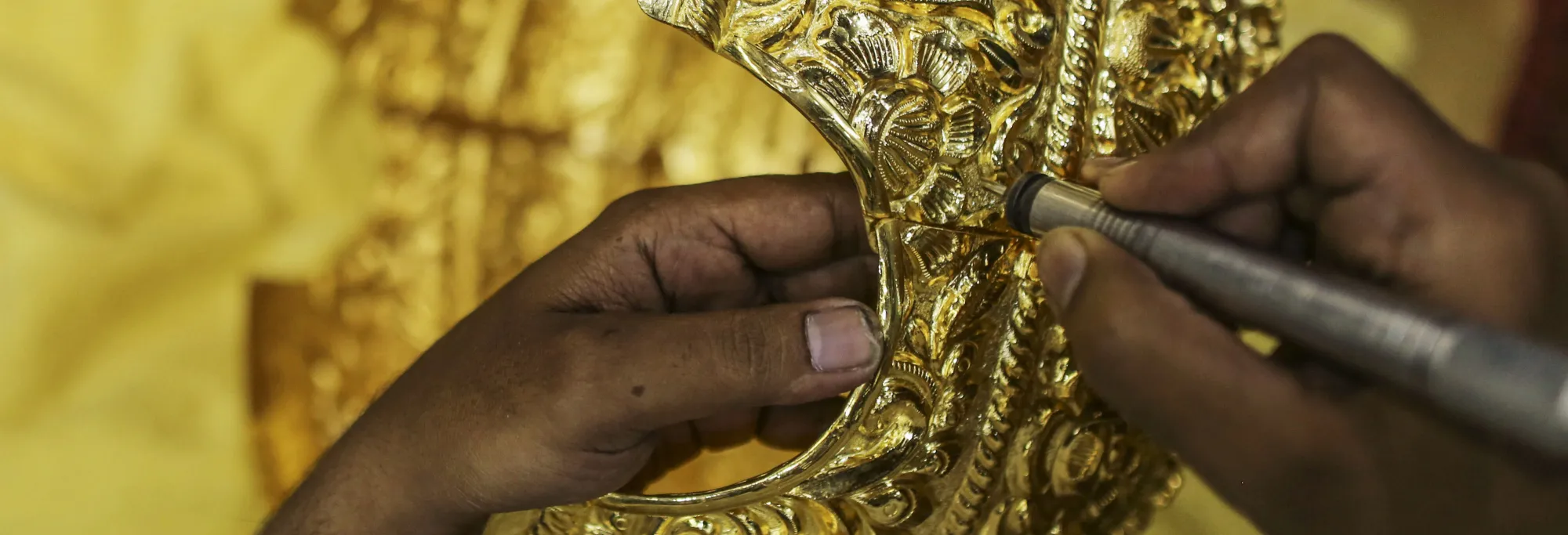 An employee works on six kg of gold crown for up coming hindu lord ganesha festival on the production line of the P. N. Gadgil Jewellers Pvt. Ltd., gold jewellery manufacturing facility in Pune, India, on Monday, Aug 17, 2017.