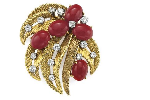 A coral and gold brooch.