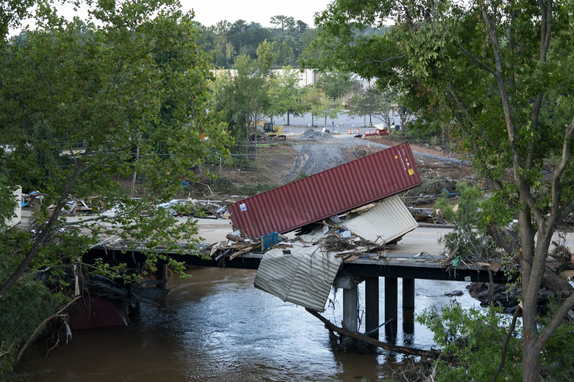 Flood damage is strewn across a road in the aftermath of Hurricane Helene on September 29, 2024 in Asheville, North Carolina.