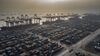 Shipping containers are stacked near gantry cranes at the Port of Nansha, operated by Guangzhou Port Group Co., in the Nansha district of Guangzhou, China, on Friday, Nov. 20, 2020. China's ability to keep selling more of its goods abroad means officials will be in no rush to rein in their strongest yuan in more than two years.