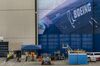 A worker rides a bicycle outside of a Boeing Co. facility in Everett, Washington, U.S., on Friday, July 24, 2020. Boeing is scheduled to release earnings figures on July 29.