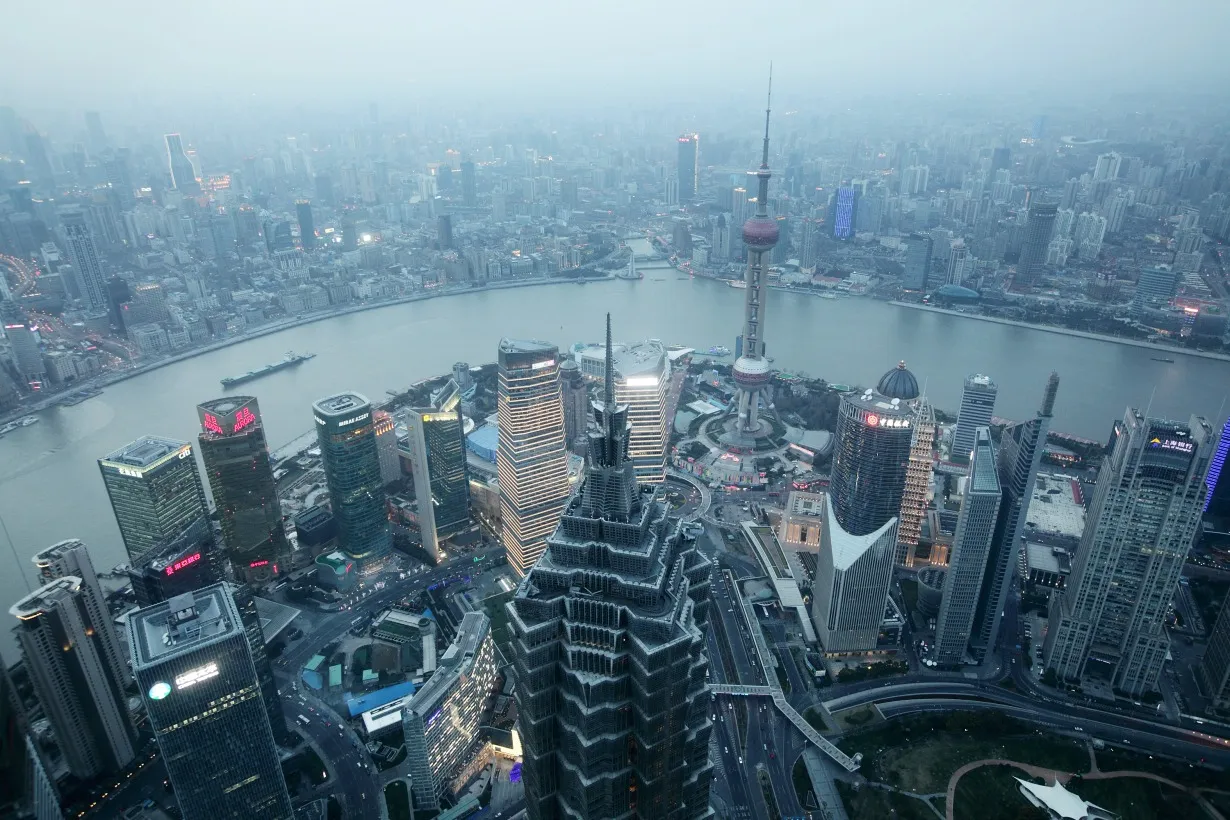 The Jin Mao Tower, center left, and the Oriental Pearl Tower, center right, stand among other commercial buildings as seen from the Shanghai World Financial Center in the Pudong area of Shanghai, China, on Saturday, Feb. 2, 2013.