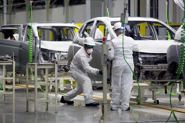 Workers build a Honda Fit vehicle on the production line after the opening ceremony for Honda’s new plant in Celaya, Mexico, on  Feb. 21
