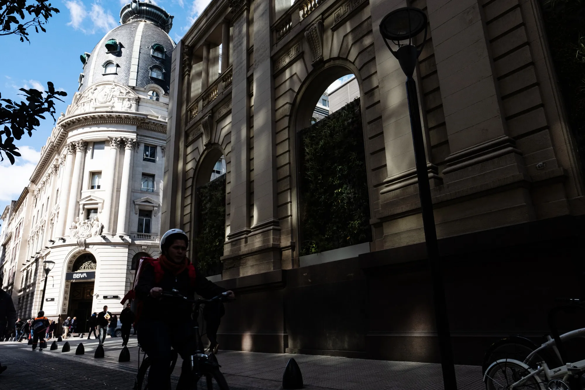 A cyclist rides down a street in the financial district in Buenos Aires, Argentina.&nbsp;