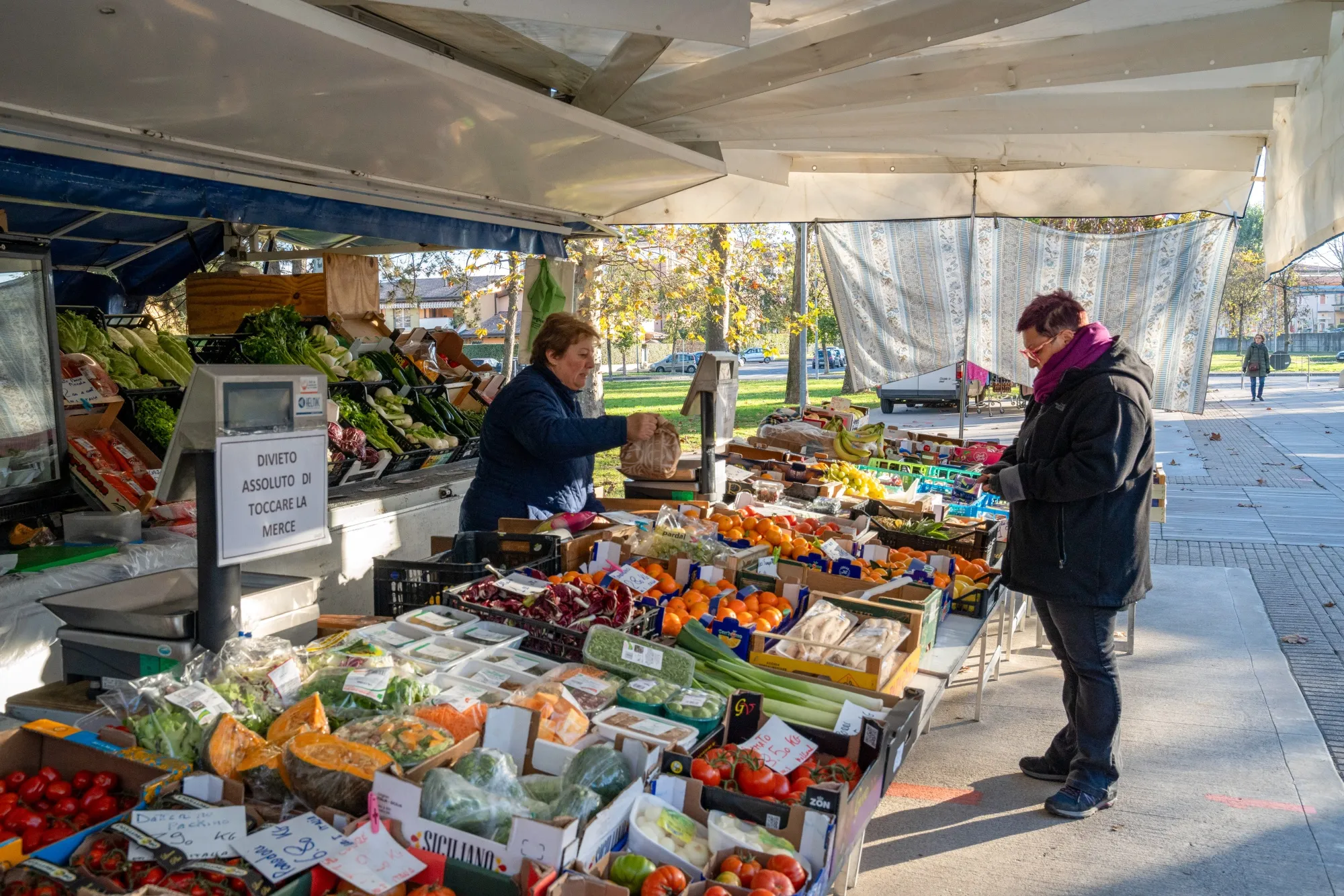 Fresh fruit and vegetables for sale at a street market stall in Brescia, Italy.