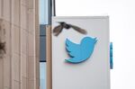 A bird flies near signage displayed outside of Twitter headquarters in San Francisco, California.