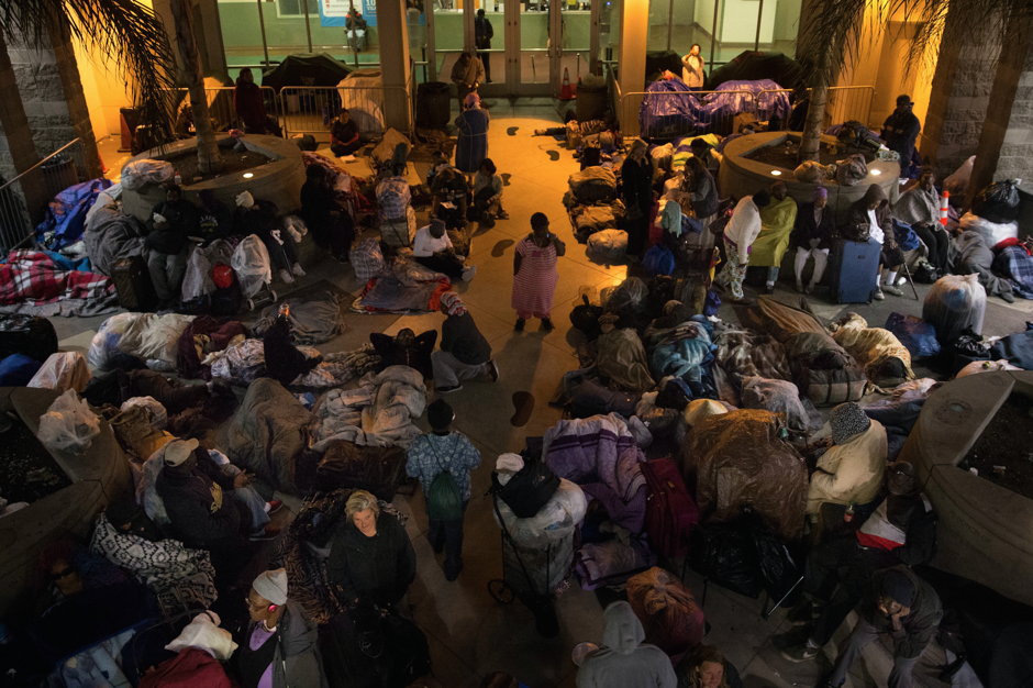 In this April 25, 2016 photo, homeless people, mostly women, spend the night in the courtyard of the Midnight Mission for their safety in Los Angeles.