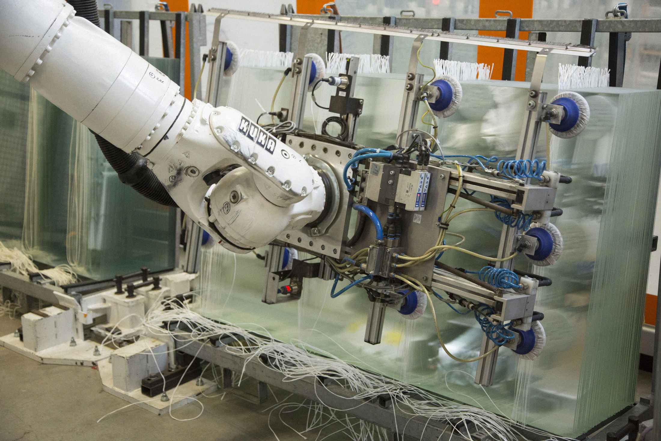 A robotic arm&nbsp;transports sheets of glass during the manufacturing of photovoltaic cells at SolarWorld AG in Freiberg, Germany.
