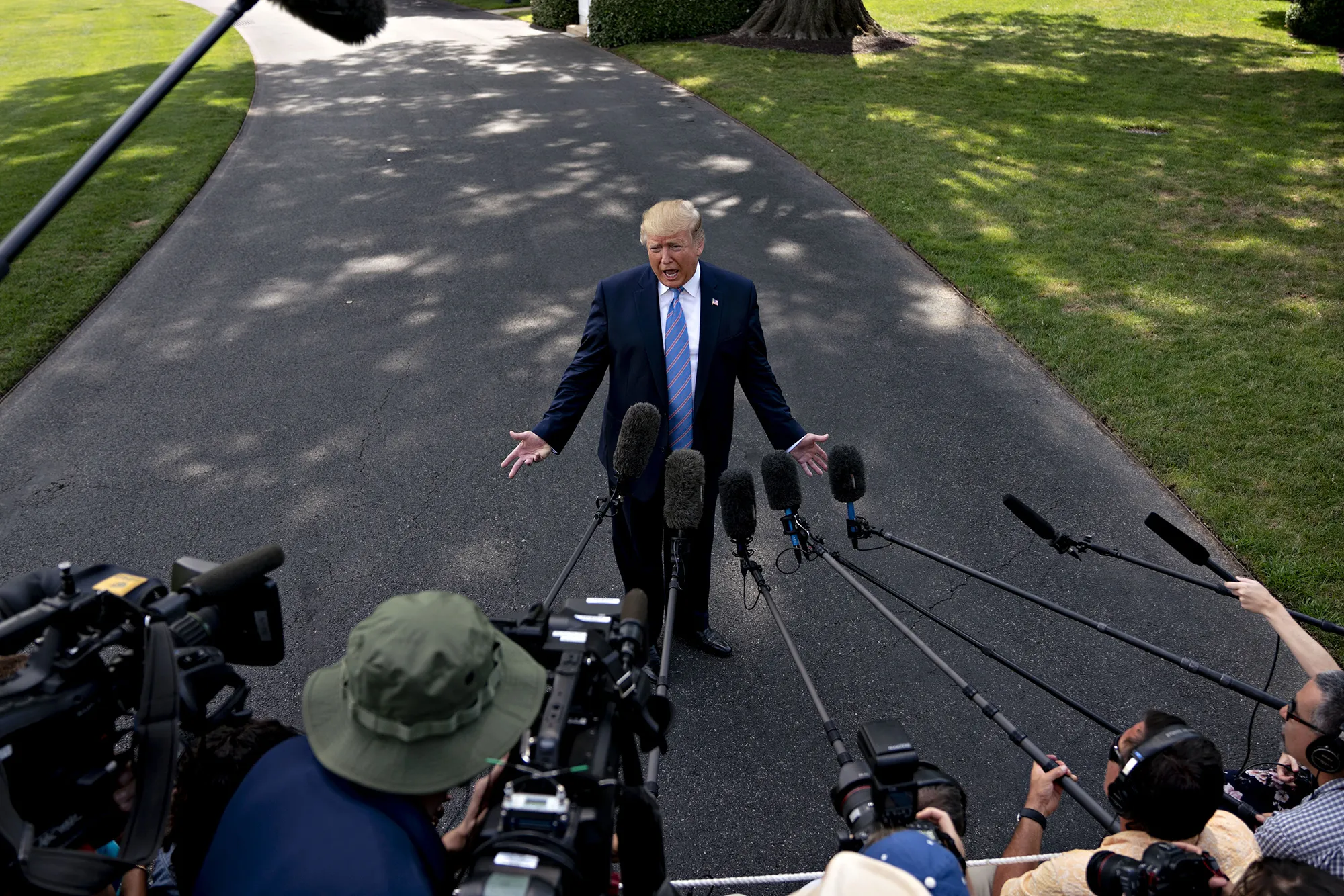 Donald Trump speaks to members of the media before boarding Marine One on the South Lawn of the White House in Washington, D.C.