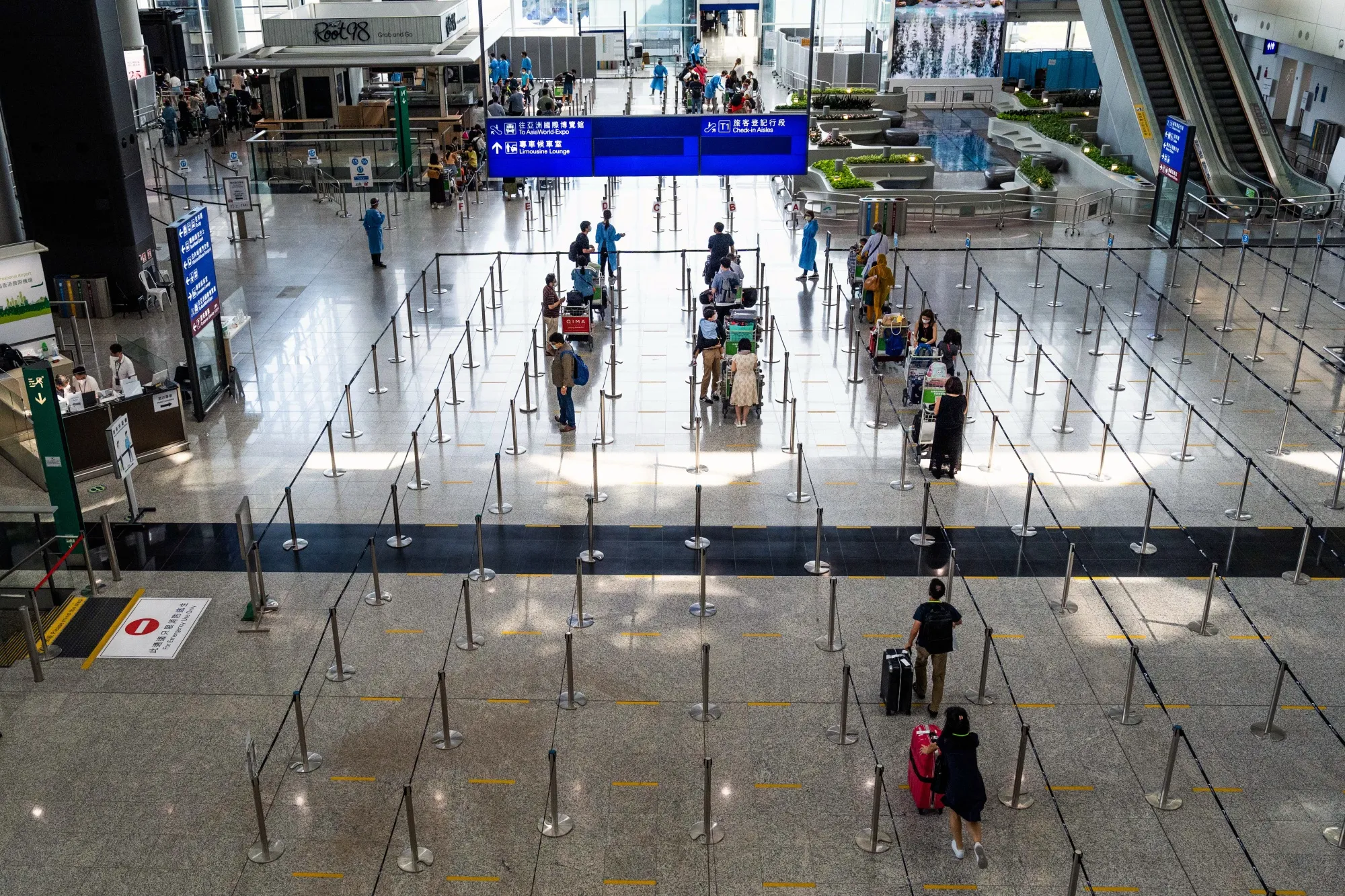 Travelers head to quarantine at Hong Kong International Airport.