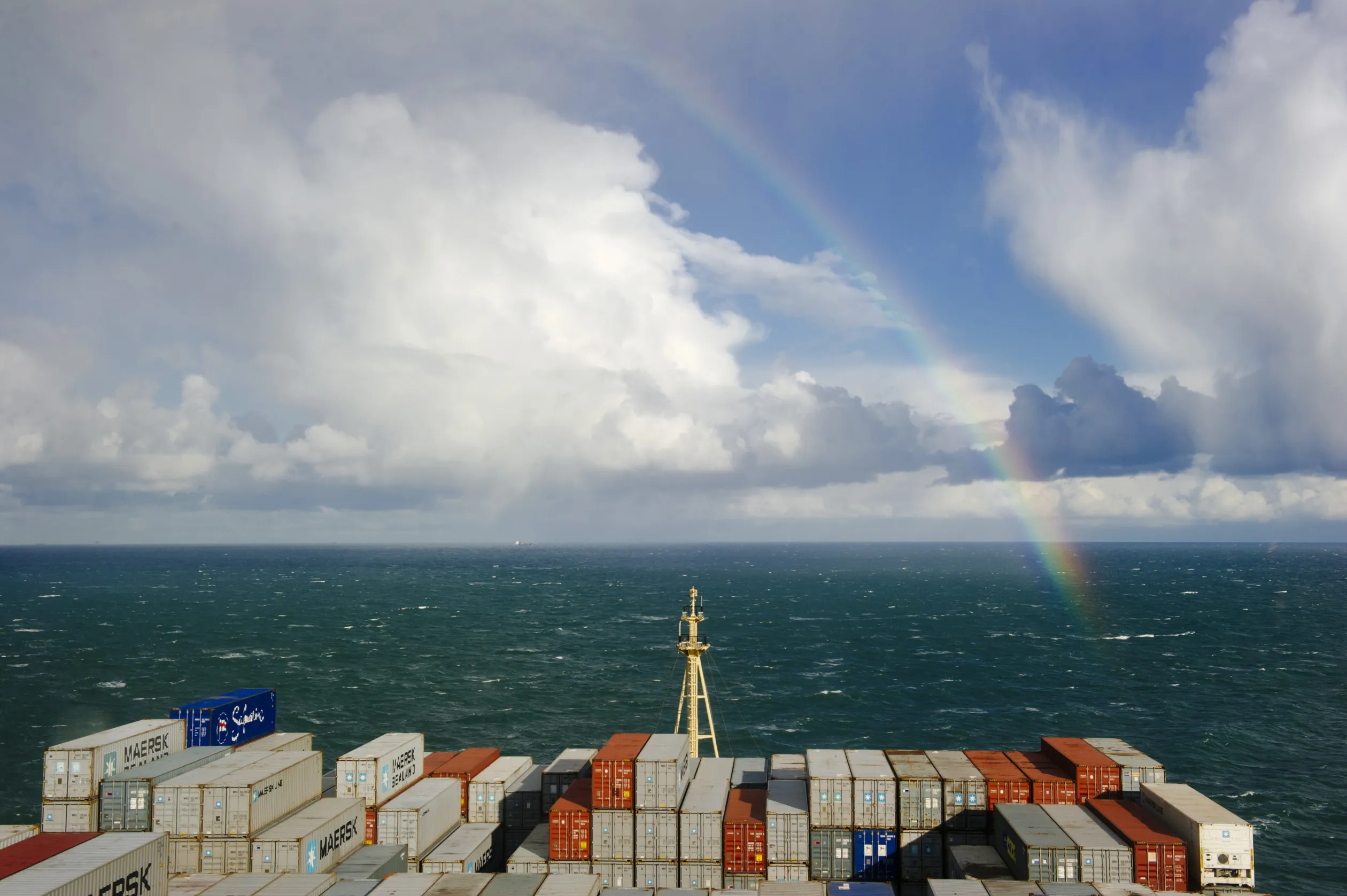 The end of a rainbow appears on the horizon over the North Sea.