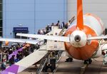 Passengers board an aircraft, operated by EasyJet Plc, at London Luton Airport in Luton, UK.