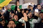 People celebrate after President Abdelaziz Bouteflika informed the Constitutional Council that he is resigning, in Algiers on April 2.