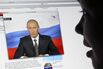A girl watches Russian President Vladimi