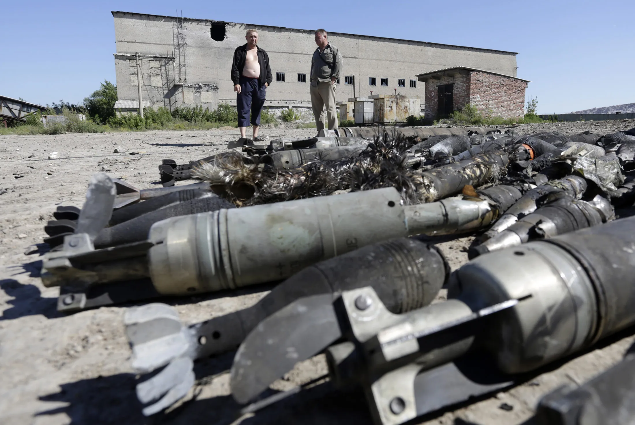 Residents of Kurdyumivka look at an ammunition depot of the Ukrainian forces destroyed by pro-Russian separatists with Russian Krasnopol guided shells after shelling in the village of Kurdyumivka, Donetsk region.
