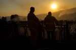 Ffirefighters&nbsp;keep watch over a home while the sun sets during the Skirball Fire in the Bel Air neighborhood of Los Angeles.