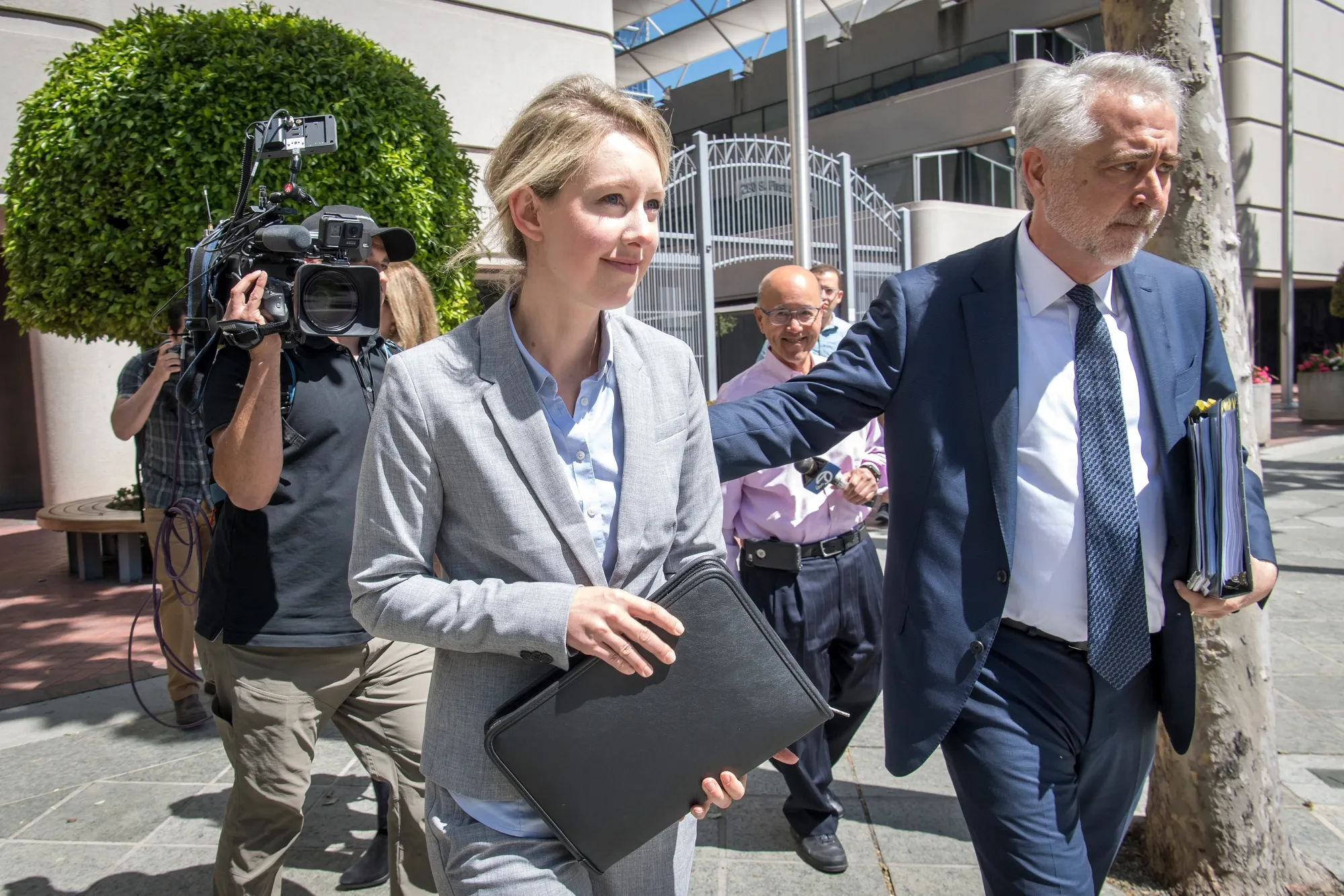Elizabeth Holmes exits federal court in San Jose, California, on April 22.