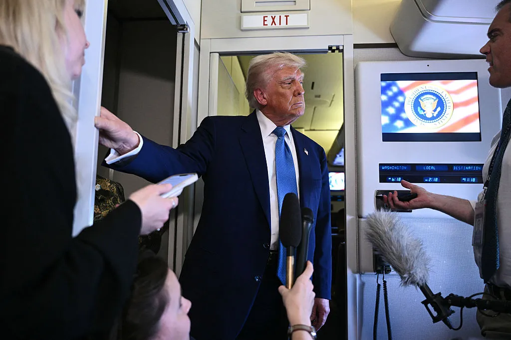 President Donald Trump speaks to members of the media accompanying him aboard Airforce One, after leaving Abu Dhabi at the end of his Middle East tour on May 16.