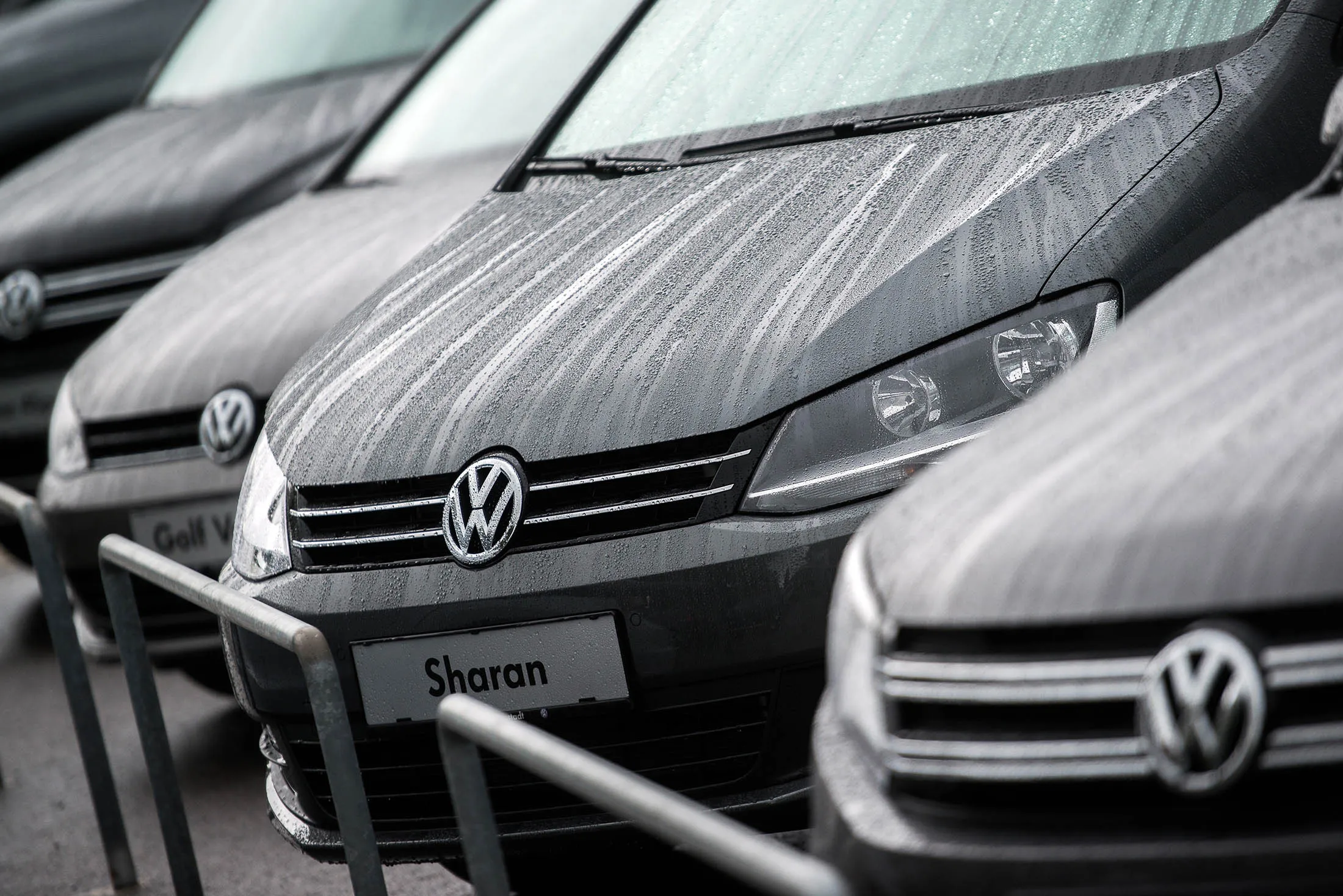 A Volkswagen badge sits on a Volkswagen Sharan automobile displayed on the forecourt of a dealership in Vienna.
