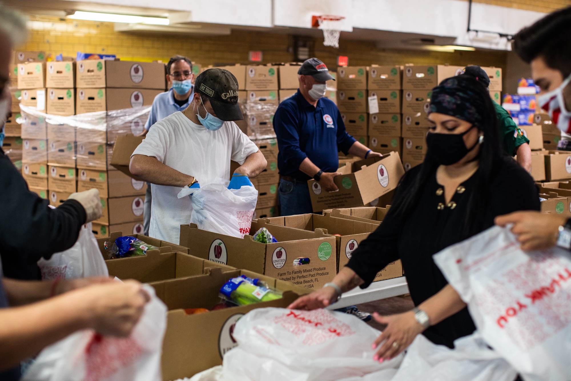 Volunteers bag groceries at a Catholic Charities Brooklyn and Queens pop-up food pantry in Brooklyn, New York, on May 29, 2020.