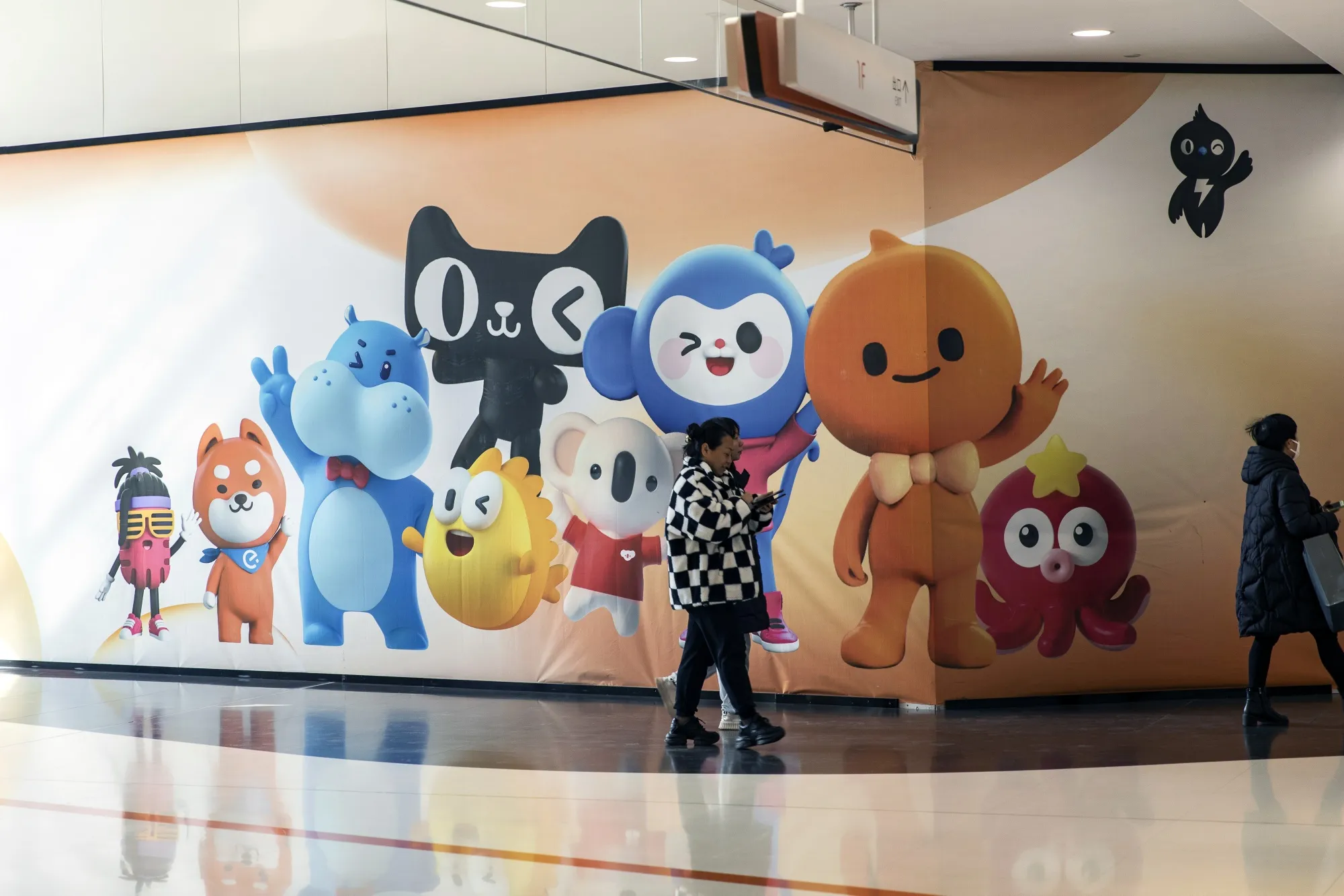 Mascots for Alibaba Group Holding Ltd.'s various platforms on a hording at a shopping mall in Hangzhou, China.
