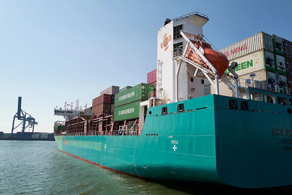 A container vessel navigates through the Port of Rotterdam.