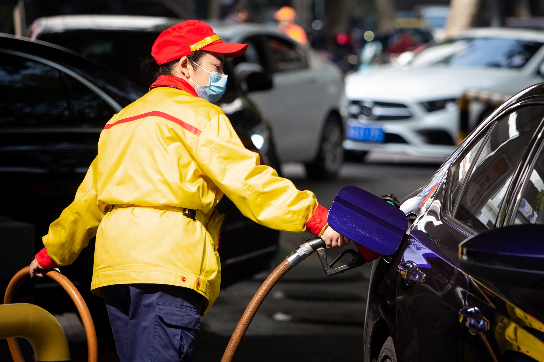 A worker refills a car at a gas station in Nanjing in east China’s Jiangsu province, on Oct. 22.