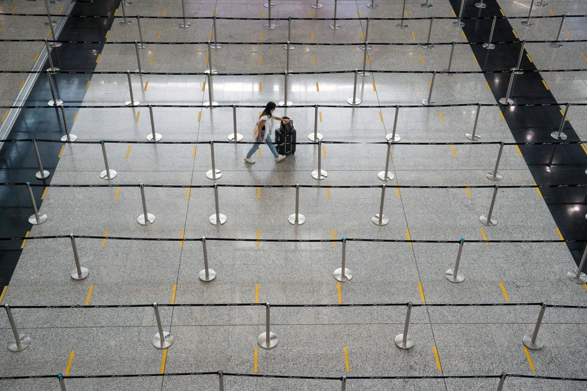 A traveler heading to quarantine in the arrival hall at Hong Kong International Airport.