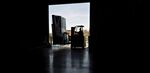 A worker uses a forklift to move packages at a robotics facility in Baltimore.