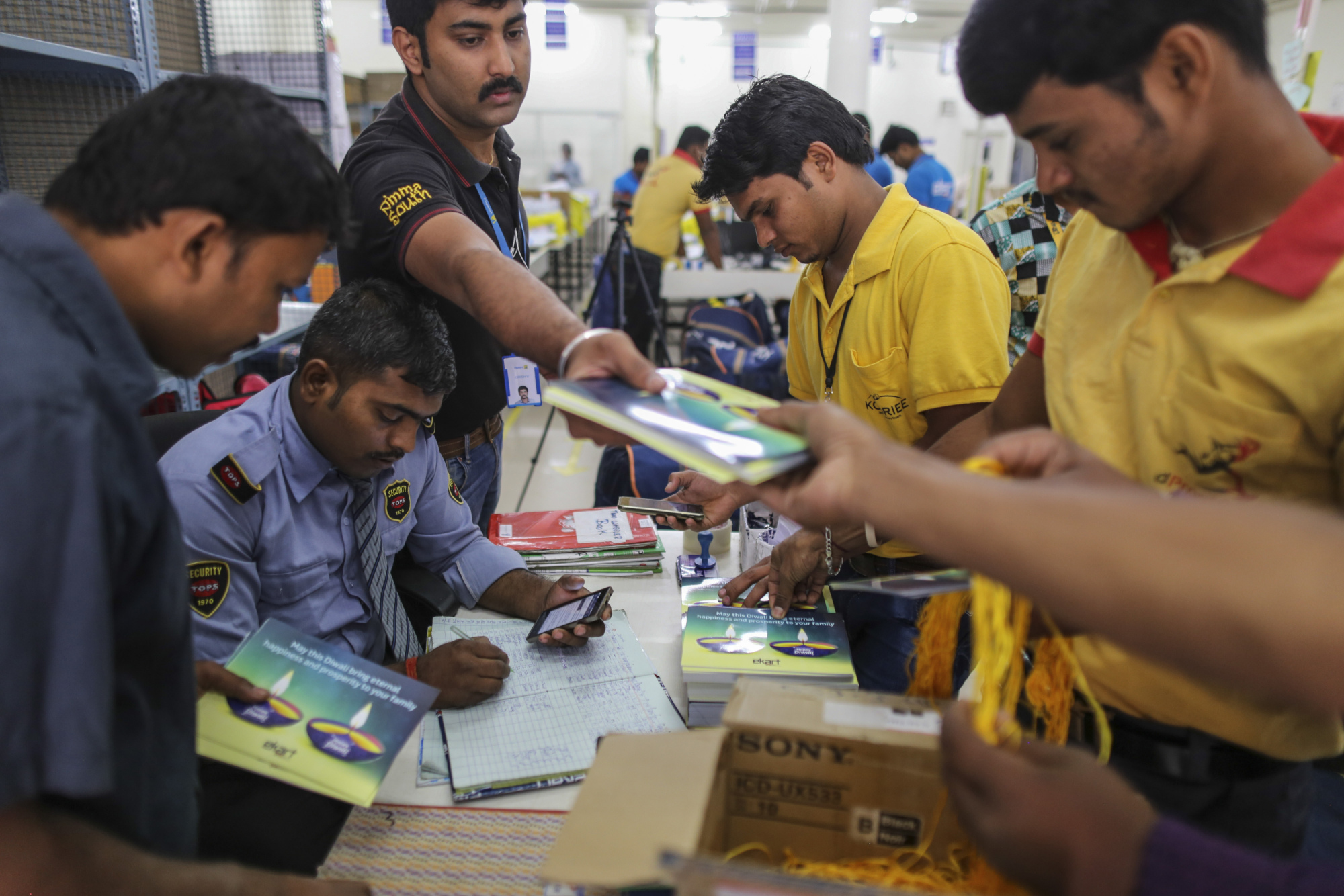 Employees collect Diwali greeting cards at a security desk ahead of delivery at the Flipkart Online Services Pvt office in the Jayaprakash Narayan Nagar area of Bengaluru, India.