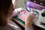 A woman makes fabric masks with a sewing machine in her home&nbsp;in Bologna, Italy on April 3.