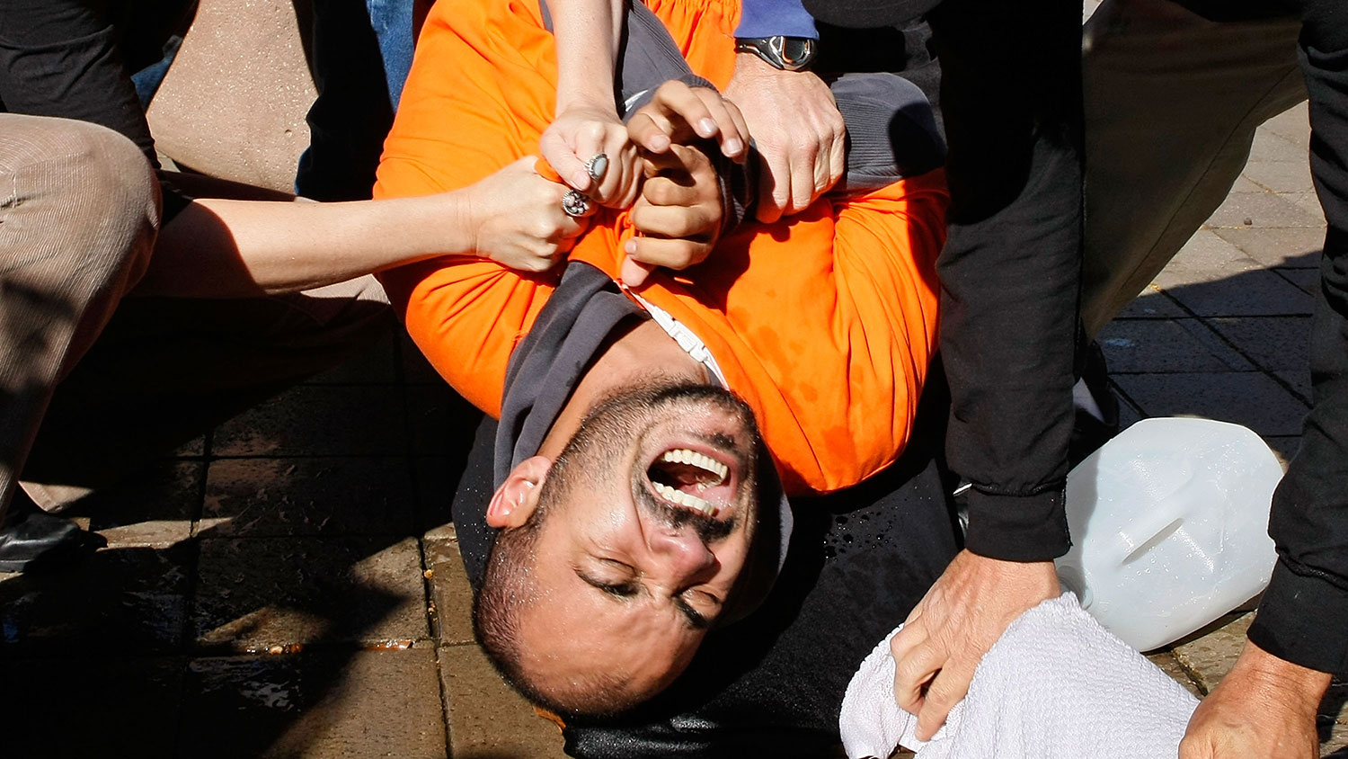 Volunteer torture victim Maboub Ebrahimzdeh is restrained as human-rights activists demonstrate waterboarding on him in front of the Justice Department on Nov. 5, 2007, in Washington.
