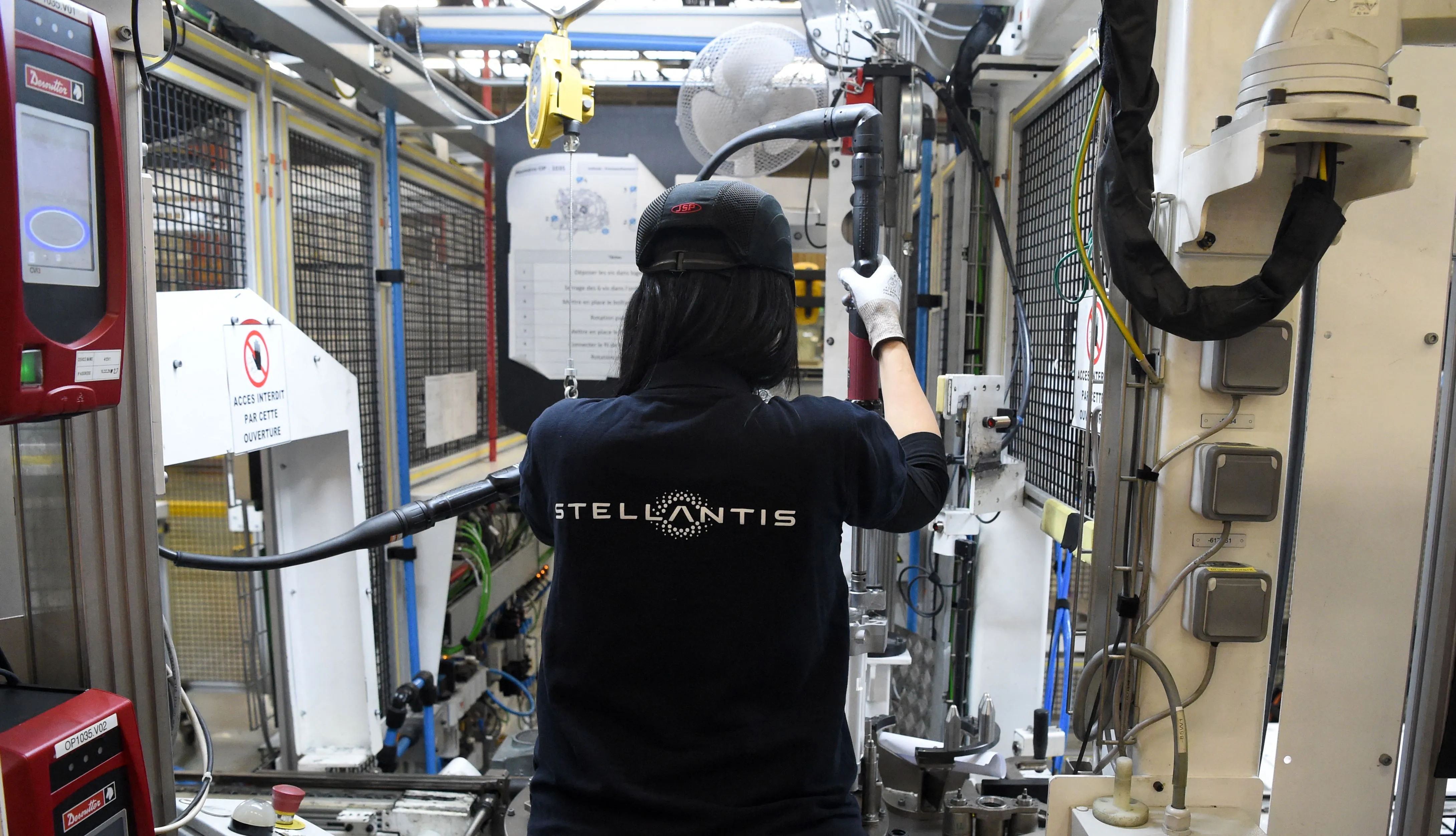 An employee works on an electric engine assembly line at the Stellantis plant in Tremery, France.