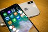 Apple Inc. iPhone X smartphones are arranged for a photograph during the sales launch at a store in New York, U.S., on Friday, Nov. 3, 2017. The $1,000 price tag on Apple Inc.'s new iPhone X didn't deter throngs of enthusiasts around the world who waited -- sometimes overnight -- in long lines with no guarantee they would walk out of the store with one of the coveted devices.