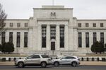 Vehicles pass in front of the U.S. Federal Reserve building in Washington, D.C., U.S.
