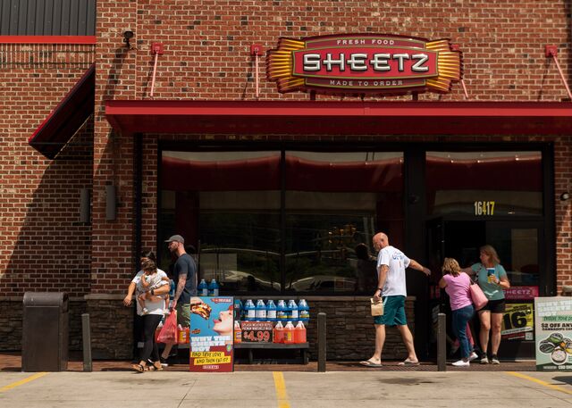 Customers exiting a Sheetz gas station store.