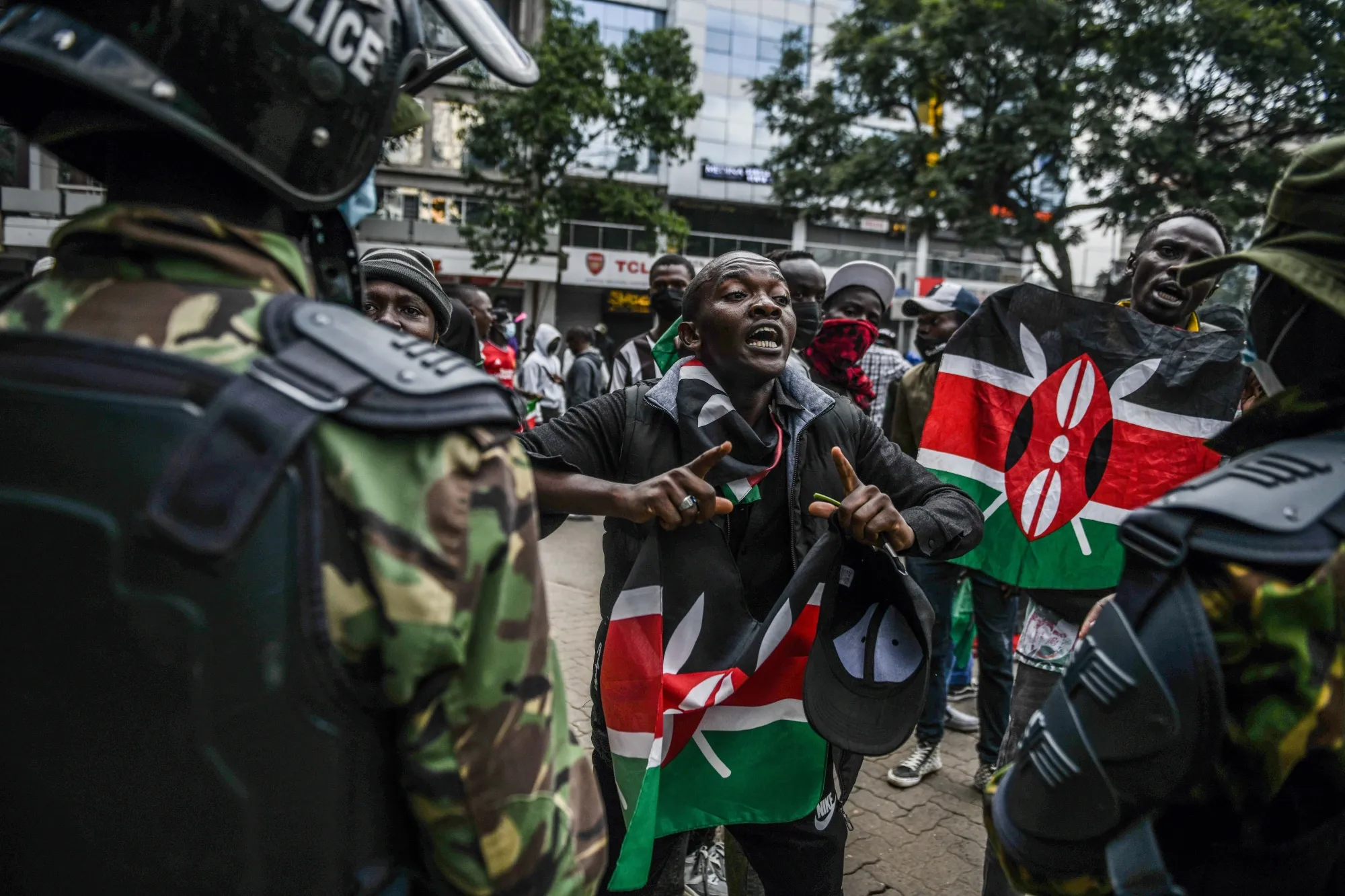 Protesters hold Kenyan flags during a demonstration in Nairobi on June 25.