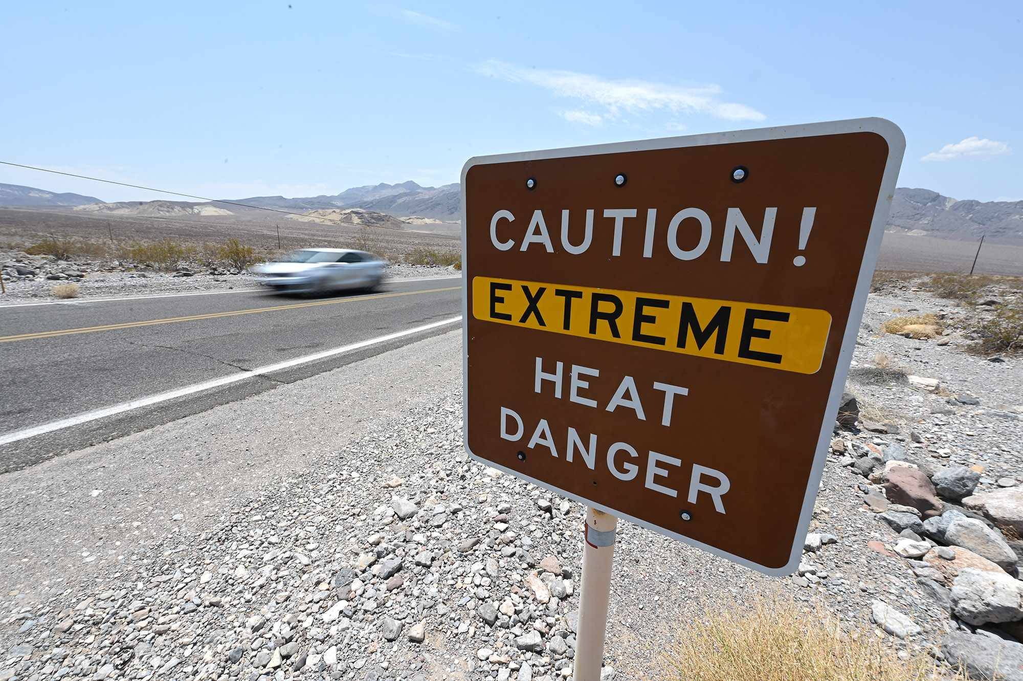 A warning sign alerts visitors of heat dangers in Death Valley National Park, California.