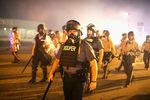 Police advance through a cloud of tear gas toward demonstrators protesting the killing of Michael Brown on Sunday in&nbsp;Ferguson, Missouri.