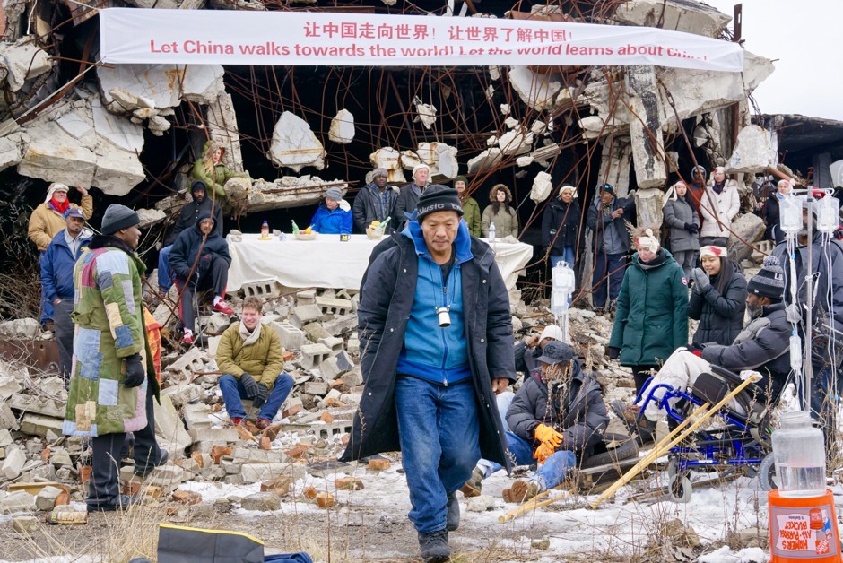 Wang Qingsong (center) directed the re-creation of &quot;The Bloody Clothes&quot; in the ruins of a candy factory in Highland Park.