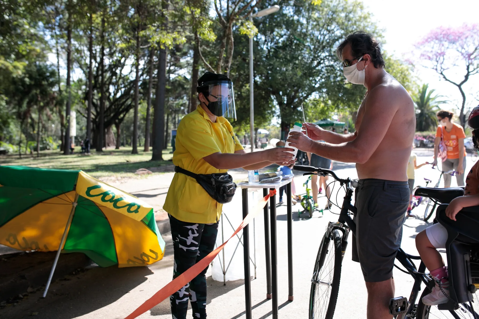 A person wearing a protective mask buys coconut water in Ibirapuera Park in Sao Paulo, Brazil, on&nbsp;July 13.