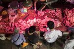 A customer picks out a pig ear at a pork stall inside the Dancun Market in Nanning, Guangxi province.